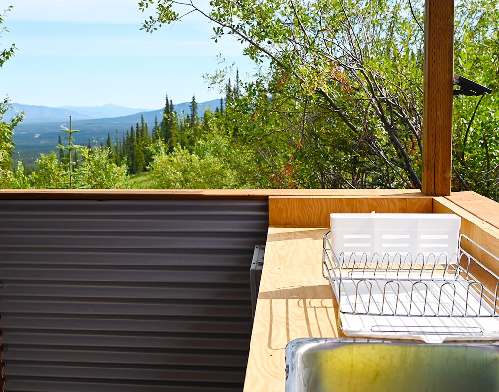 a kitchen counter with a view of the mountains